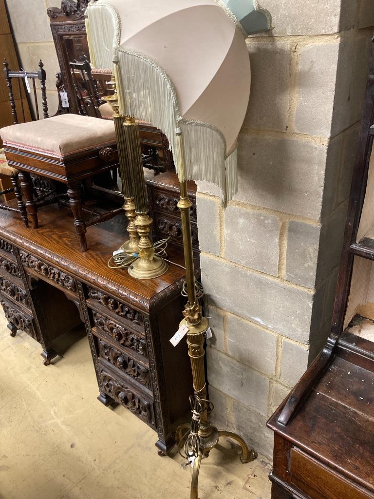 An adjustable gilt standard lamp and a pair of corinthian column lamps